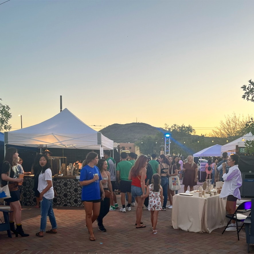 visitors peruse an outdoor market